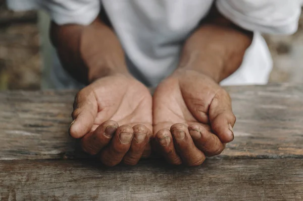 stock image Close up of male wrinkled hands palms on wooden table