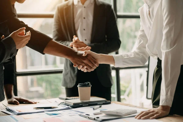 stock image business people shaking hands during meeting in office at table 