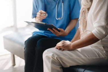  Female doctor filling up an application form while consulting patient. Medicine and health care concept. Medicine and health care concep