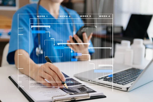 doctor working and update tasks with Gantt chart scheduling diagram at hospital .success smart medical doctor working with smart medical doctor as concept