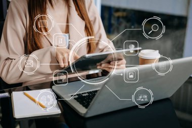 Businesswoman hand working digital marketing media in virtual screen with tablet pc and modern laptop with VR icon diagram at office