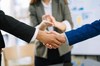 two confident businesspeople shaking hands during a meeting in the office, success, dealing, greeting and partner in sunlight