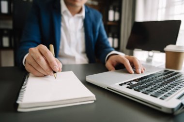 businesswoman working with new modern computer and writing on the notepad strategy diagram as concept
