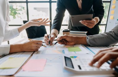 Business People Planning Strategy Analysis Office Concept. writing notes about sticky notes Laptop,tablet  Planning and Brainstorming Strategies of Colleagues