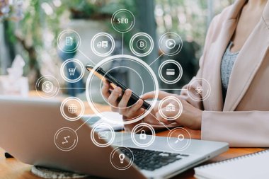 businesswoman working with mobile phone and tablet and laptop computer Internet with Augmented Reality on VR dashboard on desk in office