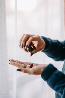 Woman Depression holding bottle with pills on hand going to take medicament prescribed by his doctor