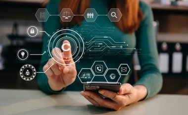 Copyright or patent concept, businesswoman using tablet and smartphone with virtual screen copyright icon trademark, Creation ownership against piracy. at office