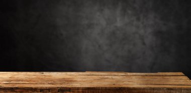 Empty dark wooden table in front  background of plaster Texture of old gray concrete clipart