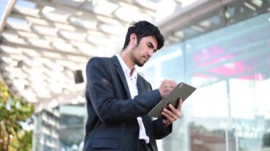 Businessman  using  tablet  at outside 