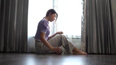 woman sitting with Depression and anxiety by window