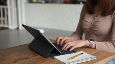 Businesswoman  using  tablet with social network  on desk as concept
