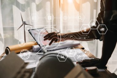 Creative architect projecting on the big drawings in the dark loft office in morning light