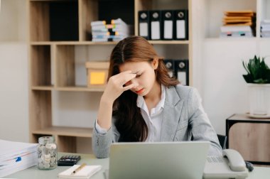 portrait of stressed businesswoman with laptop in the modern office.