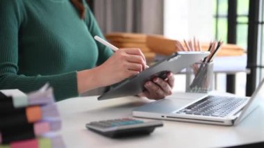 Businesswoman  using  tablet on desk as concept