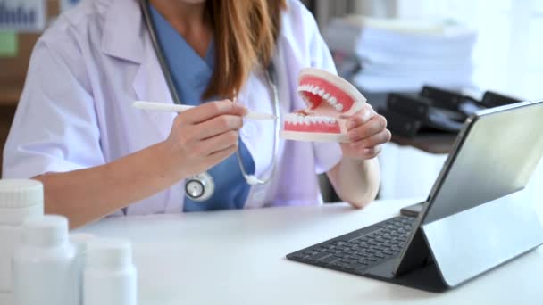 Zahnarzt Sitzt Tisch Mit Kieferproben Zahnmodell Und Arbeitet Mit Tablette — Stockvideo
