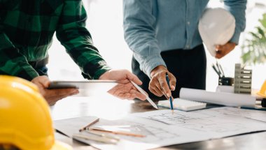 Creative architect projecting on  drawings in  office  in morning light