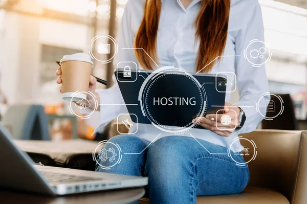 Web hosting concept, woman using  laptop, tablet and  virtual screen inscription Hosting on desk, Internet, business, digital technology concept