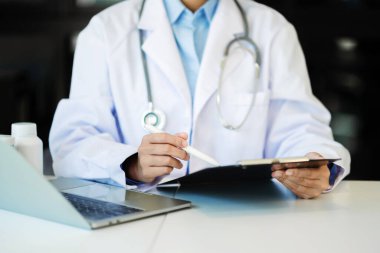 Doctor working with stethoscope and laptop in modern office. Medical technology concept.