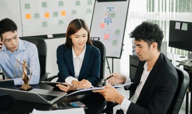  business team or  lawyers discussing contract papers sitting at the table. Concepts of law, advice, legal services. at modern office
