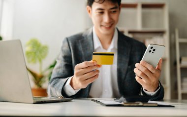 Man using smart phone and credit card for mobile payments online shopping,omni channel