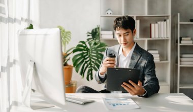 Young Asian businessman working at office with computer
