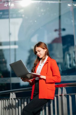  Asian business woman holding laptop.Office worker at business center