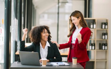 Young , creative businesspeople celebrating achievement and in planning design in creative in modern office