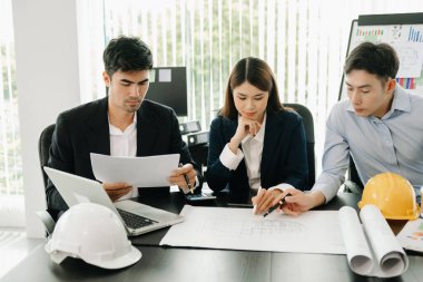 Creative architect team and big drawings in  office 