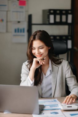 Young beautiful woman and laptop in modern office