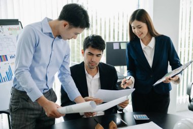 Creative architect team and big drawings in  office 