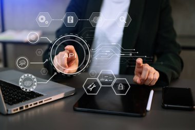 API Application Programming Interface, woman using laptop, tablet and smartphone with virtual screen API icon Software development tool, modern technology and networking concept. in office