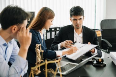  business team or  lawyers discussing contract papers sitting at the table. Concepts of law, advice, legal services. at modern office