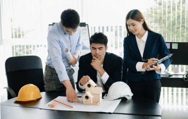 Creative architect team and big drawings in  office 