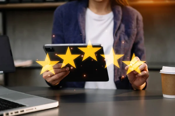 businesswoman , Customer or client the stars to complete five stars. giving a five star rating. Service rating, satisfaction concept. at office