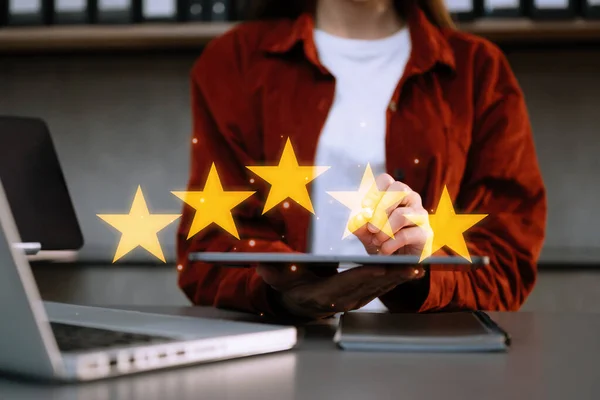 businesswoman , Customer or client the stars to complete five stars. giving a five star rating. Service rating, satisfaction concept. at office