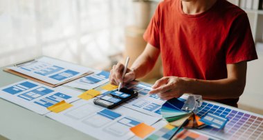 UX graphic designer planning application process development prototype wireframe for web smart phone. Creative digital development agency. in office