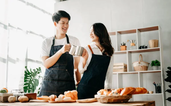 Asia lovers or couple cooking in kitchen with  Bread on table.