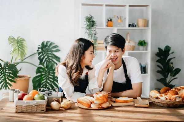 Asia lovers or couple cooking in kitchen with  Bread on table.