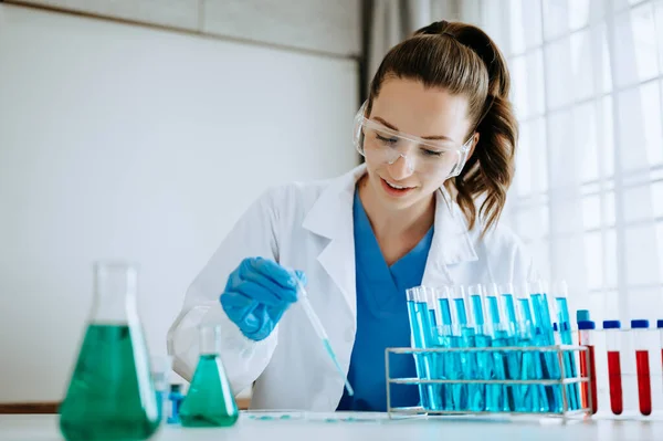 Female biotechnologist testing new chemical substances in a laboratory.