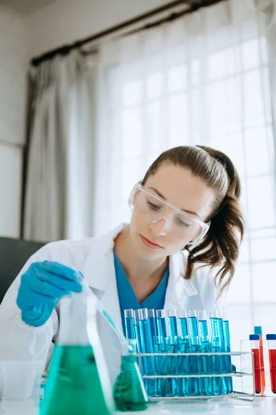 Female biotechnologist testing new chemical substances in a laboratory.