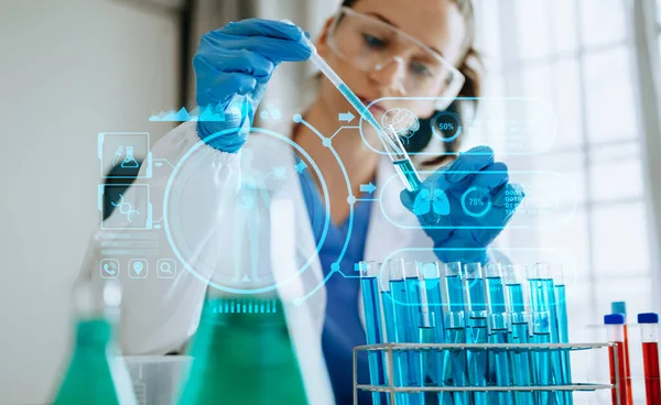 stock image DNA molecule testing concepts. The doctor in a mask examines DNA molecules on the chemical laboratory with virtual icon