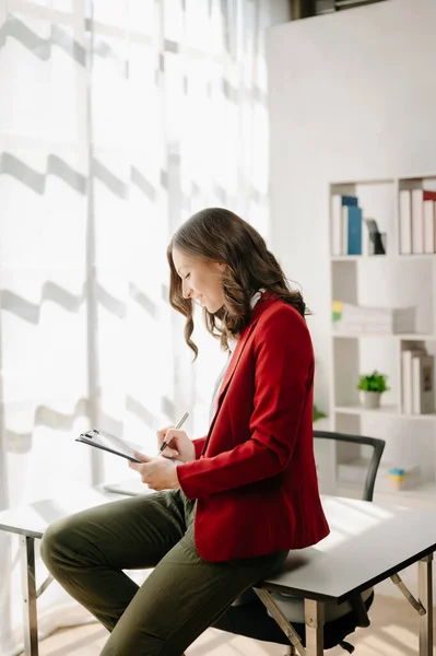 stock image Young attractive  female office worker in business suit  in office 