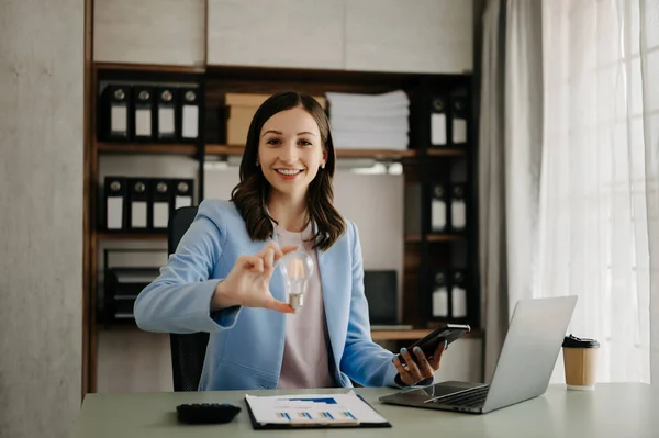 stock image business woman hand showing creative business strategy with light bulb as concept in office