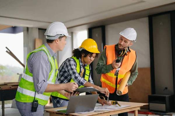 stock image Engineers are discussing data working and laptop  with architectural project at new construction site on big project. team work