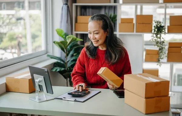 Senior business owner woman  check online orders for deliver to customer , Shopping Online concept