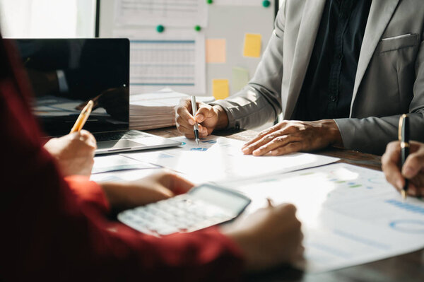Businesspeople with calculator on office table and graph business with social network diagram 
