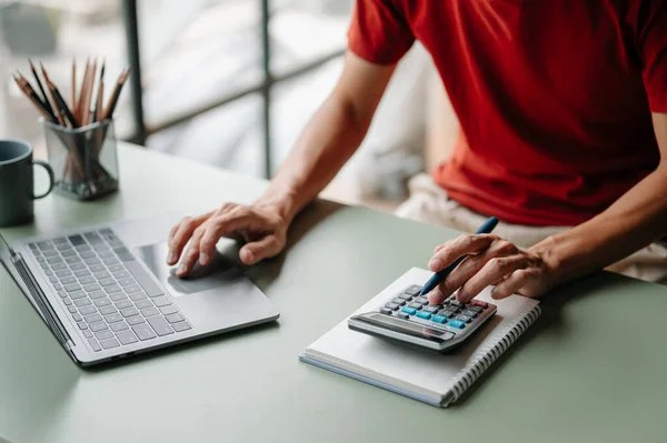 stock image man with calculator and laptop at office