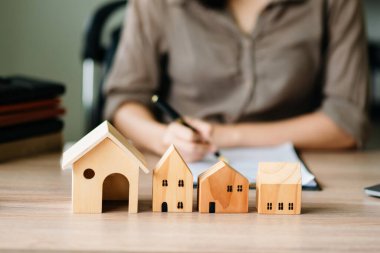 Considering buying a home, investing in real estate. Broker signs a sales agreement. agent, lease agreement, successful deal 
