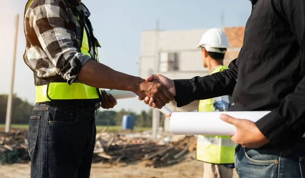Construction team shake hands greeting start new project plan