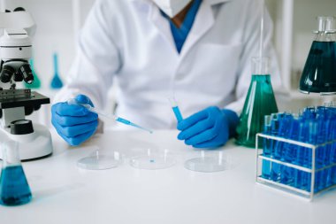 Scientist mixing chemical liquids in the chemistry lab. Researcher working in the chemical laboratory